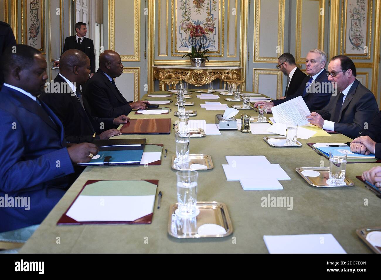 France's President Francois Hollande (R) and France's Minister of Foreign Affairs Jean-Marc Ayrault (2-R) speak with Central African Republic's president Faustin-Archange Touadera (L) on March 20, 2017 at the Elysee Palace in Paris, France. Photo by Eliot Blondet/ABACAPRESS.COM Stock Photo