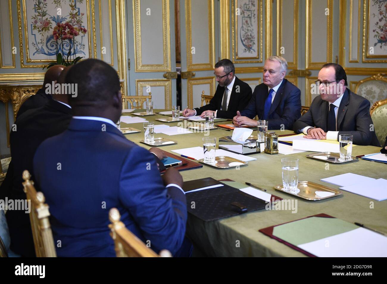 France's President Francois Hollande (R) and France's Minister of Foreign Affairs Jean-Marc Ayrault (2-R) speak with Central African Republic's president Faustin-Archange Touadera (L) on March 20, 2017 at the Elysee Palace in Paris, France. Photo by Eliot Blondet/ABACAPRESS.COM Stock Photo