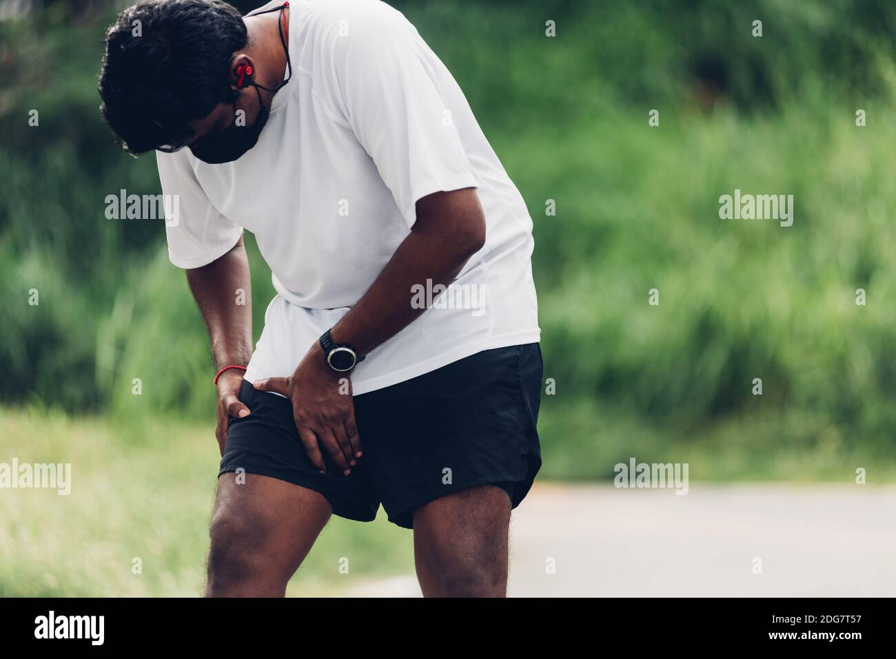 Close up Asian young sport runner black man wear watch hands joint hold