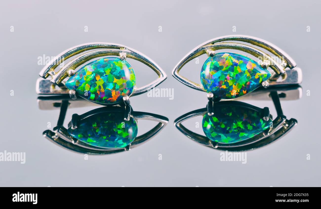 Silver earrings in the shape of human eyes with multicolored stones Stock Photo Alamy