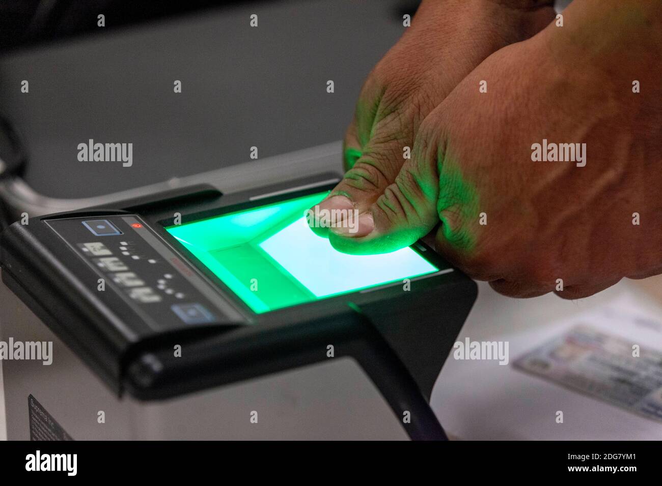 Columbus, Ohio, USA. 5th Dec, 2020. El Salvadoran immigrant scans his thumbs at a fingerprint scanner for a new Documento Unico de Identidad (DUI), the national identification card of El Salvador.The El Salvadoran Consulate is responsible for processing identification materials for immigrants from El Salvador who live in 11 different states including North and South Dakota, Minnesota, Wisconsin, Illinois, Indiana, Michigan, Ohio, Iowa, Missouri and Kentucky. It is difficult for immigrants who do not live in Illinois to travel to Chicago, so the El Salvadoran consulate does a pop Stock Photo