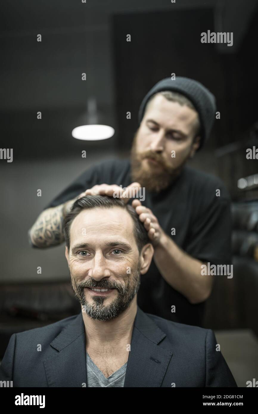 Making hairstyle in barbershop Stock Photo