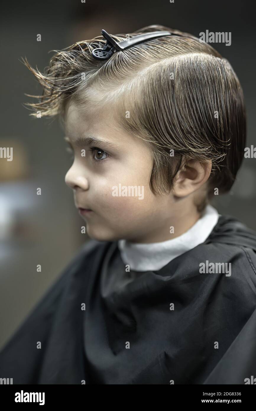 Portrait of little boy in barbershop Stock Photo