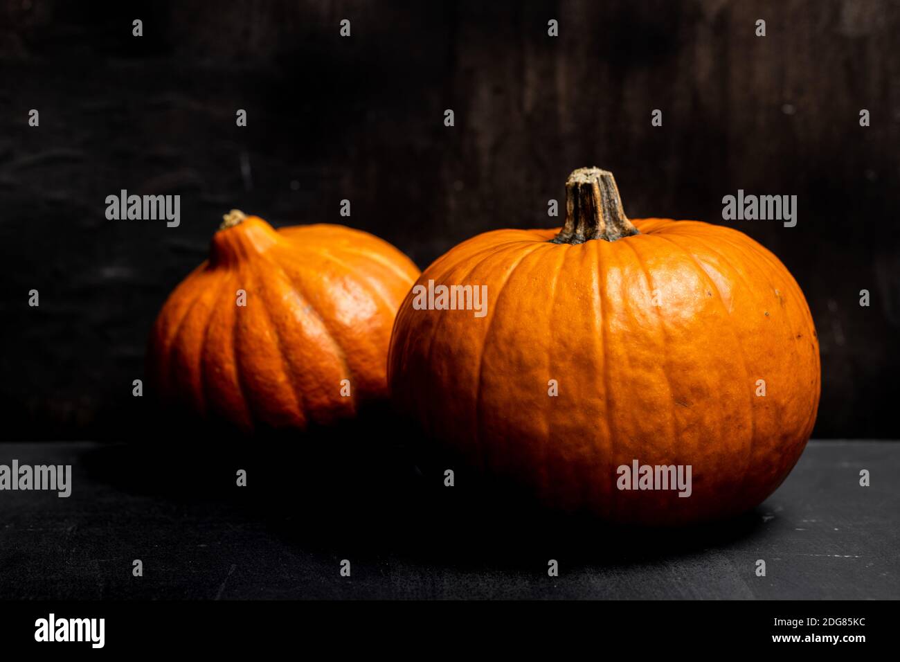 Autumn pumpkins dark mood black background Stock Photo - Alamy