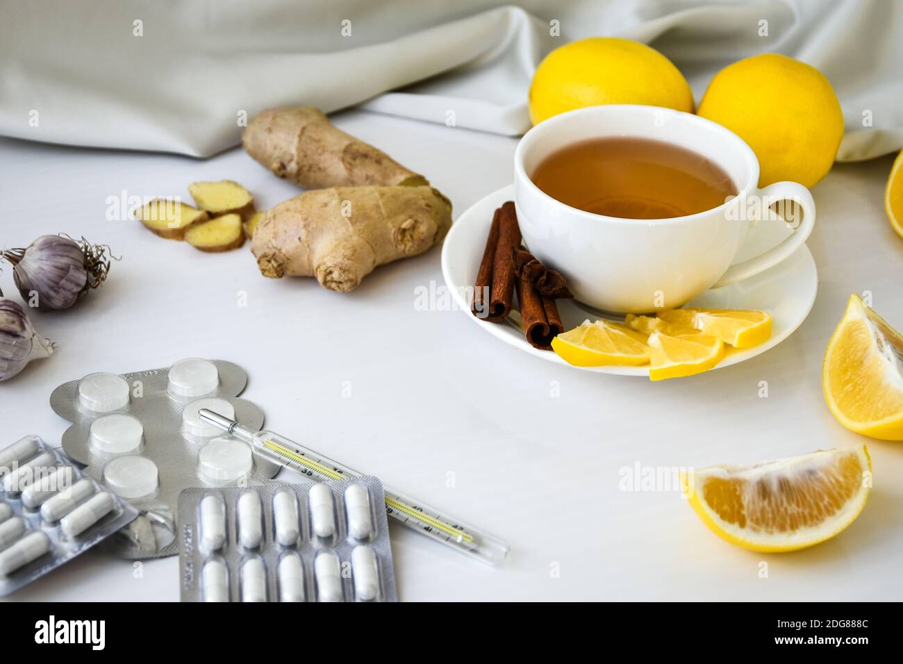 Products for the treatment of common cold - lemon, ginger, chamomile tea. Vitamin natural drink. Cinnamon anise star. Natural medicine vs conventional Stock Photo