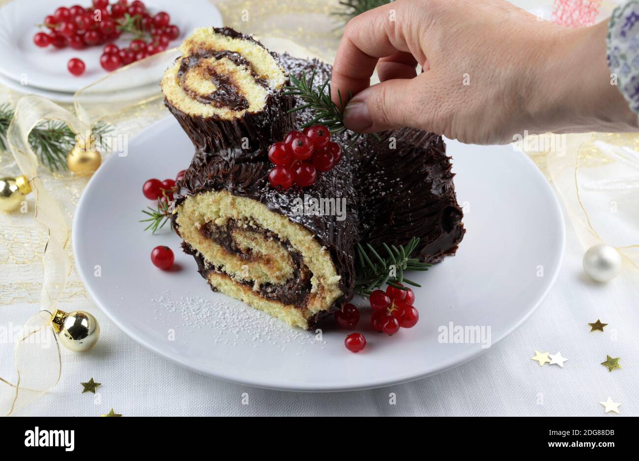 Chocolate Christmas Yule Log, Buche de Noel on white background. Christmas decorations Stock Photo