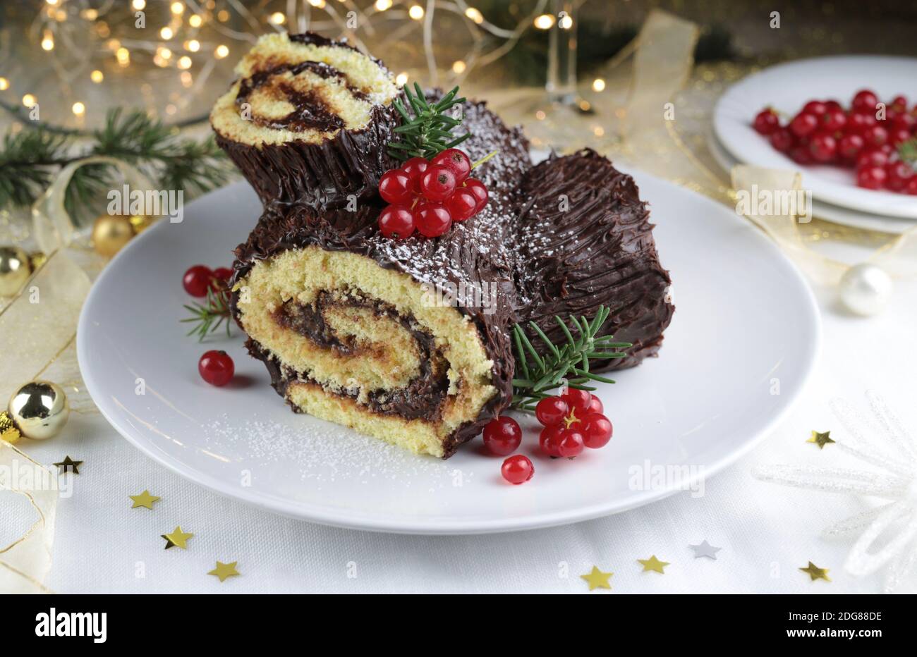 Chocolate Christmas Yule Log, Buche de Noel on white background. Christmas decorations Stock Photo