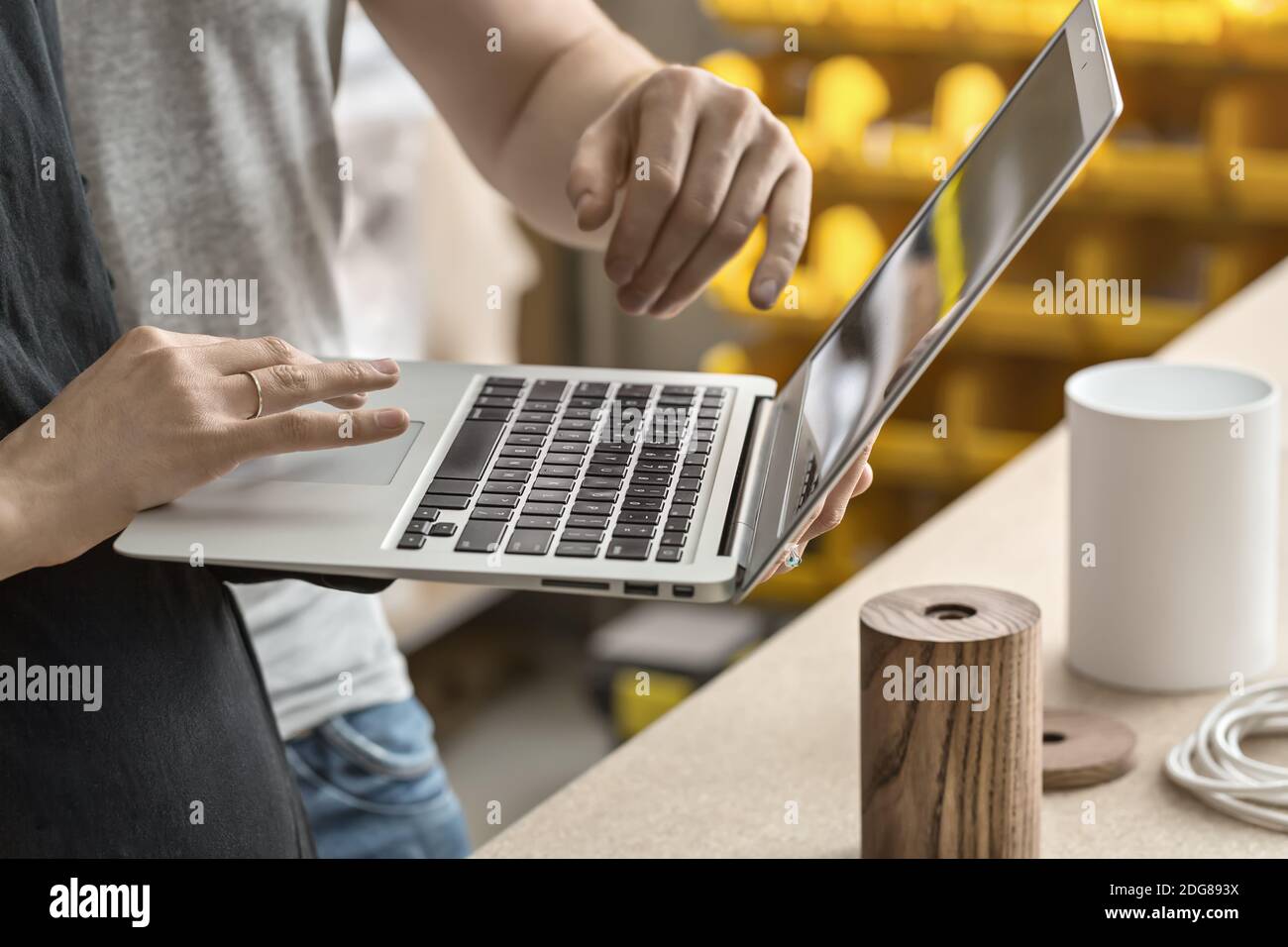 Couple using laptop in workshop Stock Photo