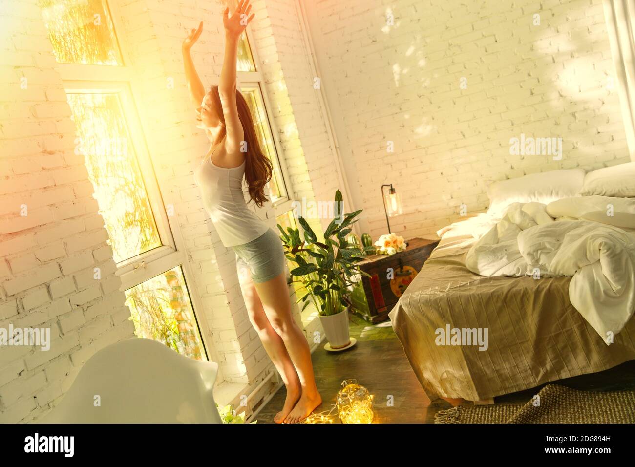 The window and stretch young woman Stock Photo - Alamy
