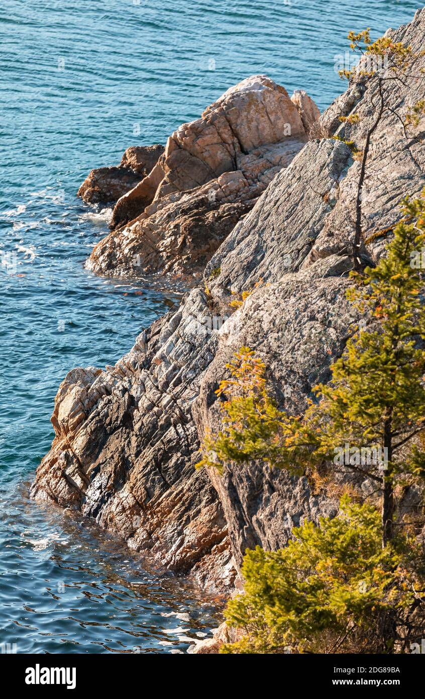 Seascape with turquoise waves washing over the rugged rocky coast in British Columbia/Canada. Selective focus, travel photo, nobody. Stock Photo