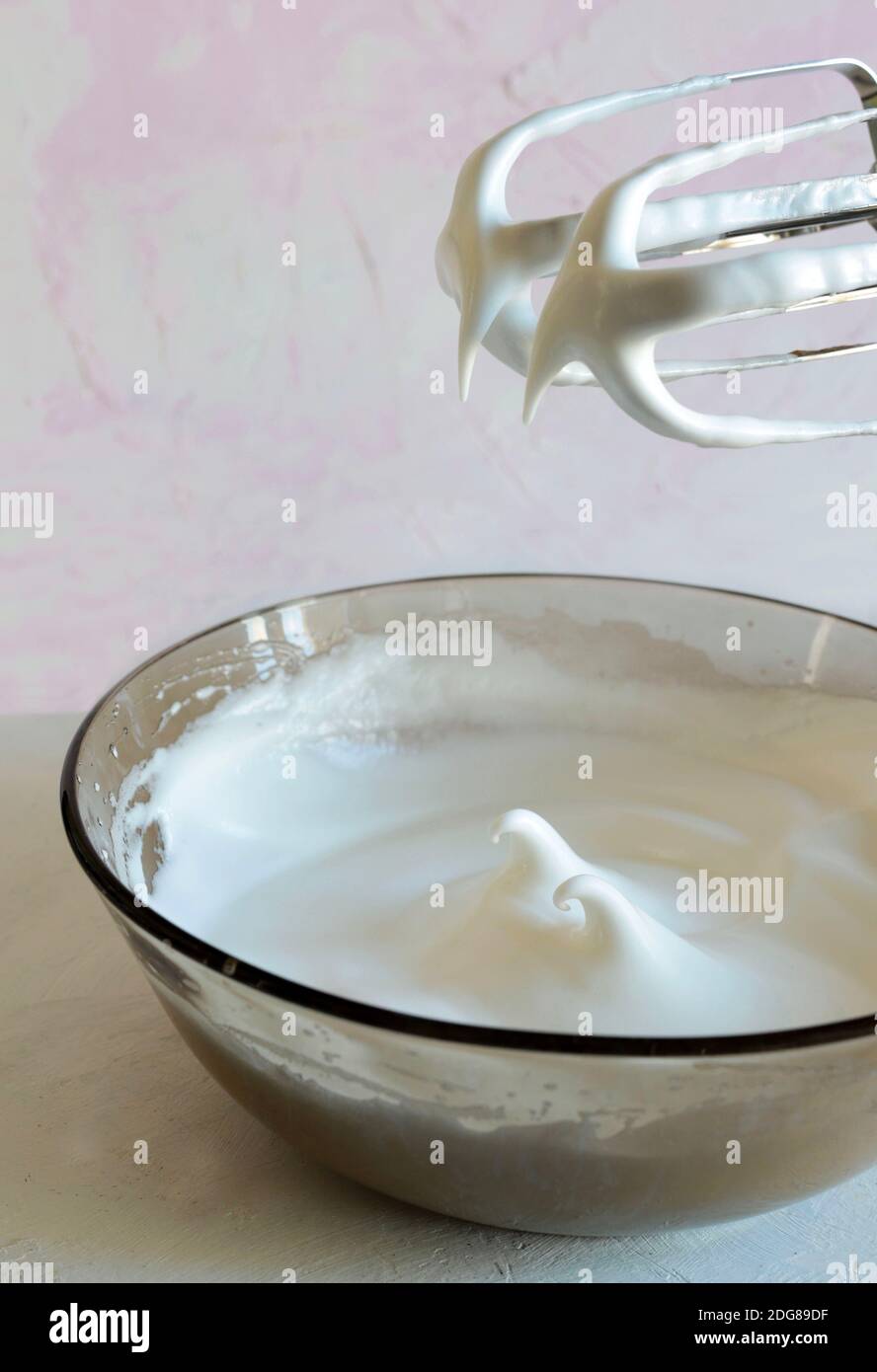 Electric hand mixer with whipped cream Stock Photo Alamy