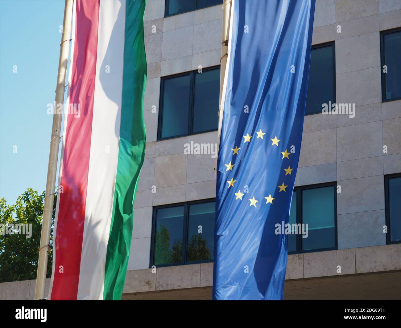 European Union and Hungarian flag in front of an office building Stock Photo