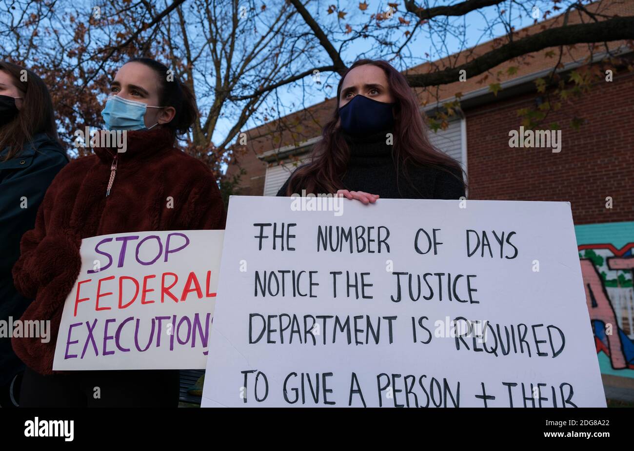College students and community members wearing face masks hold placards while gathering in Peoples Park to protest against the death penalty, and a wave of executions at the Terre Haute federal prison (Federal Correctional Complex at Terre Haute) during the last months of Donald J. Trump's presidency. The federal government has already executed 8 prisoners on death row, and several more are scheduled to be put to death before January 20th. Billie Allen, who maintains his innocence, but is on death row, spoke to the group via a phone call from prison. Stock Photo