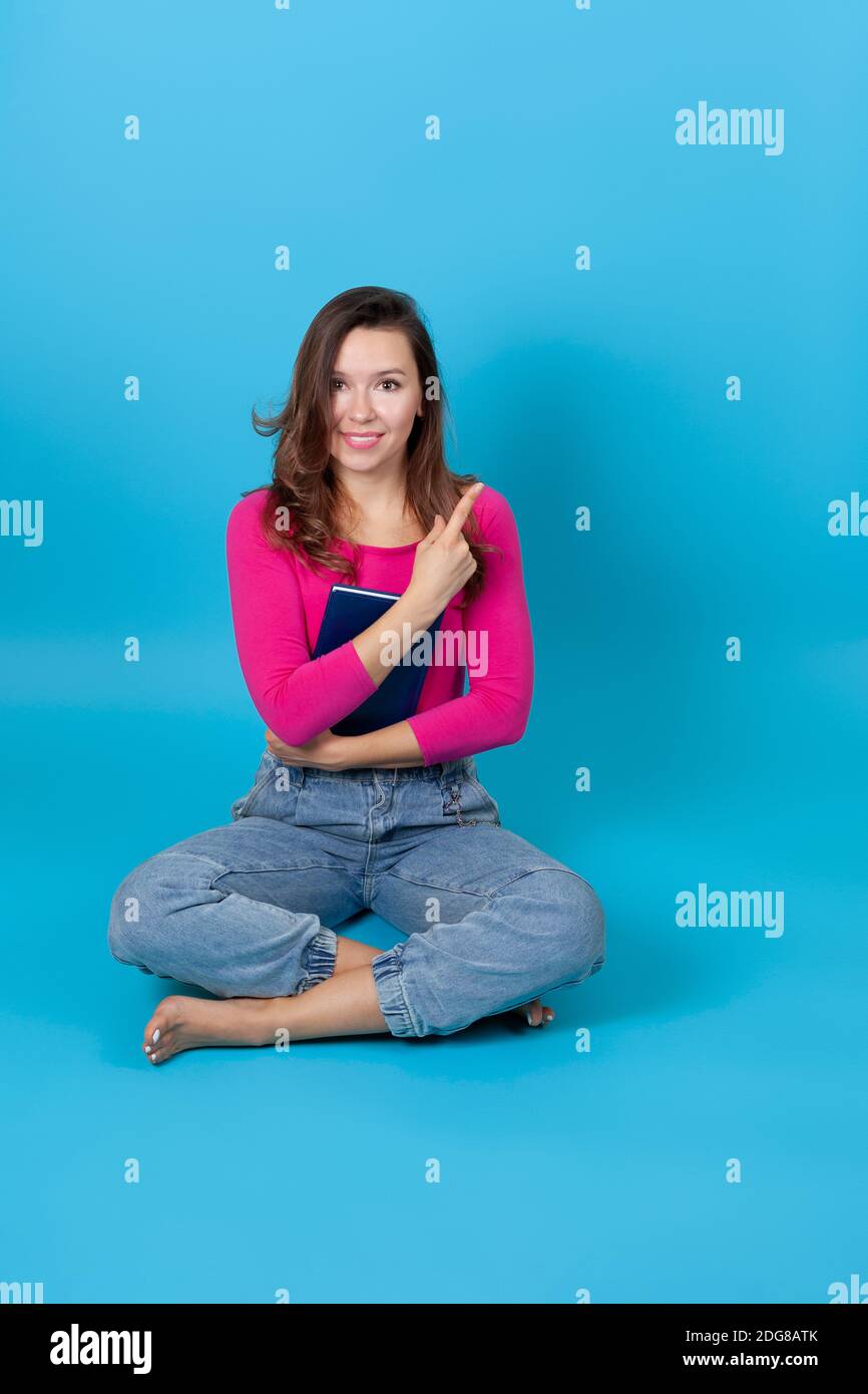 Woman pointing finger up sit hi-res stock photography and images - Alamy