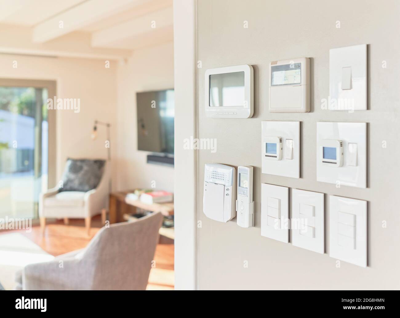 Home automation touch screens and switches on wall Stock Photo