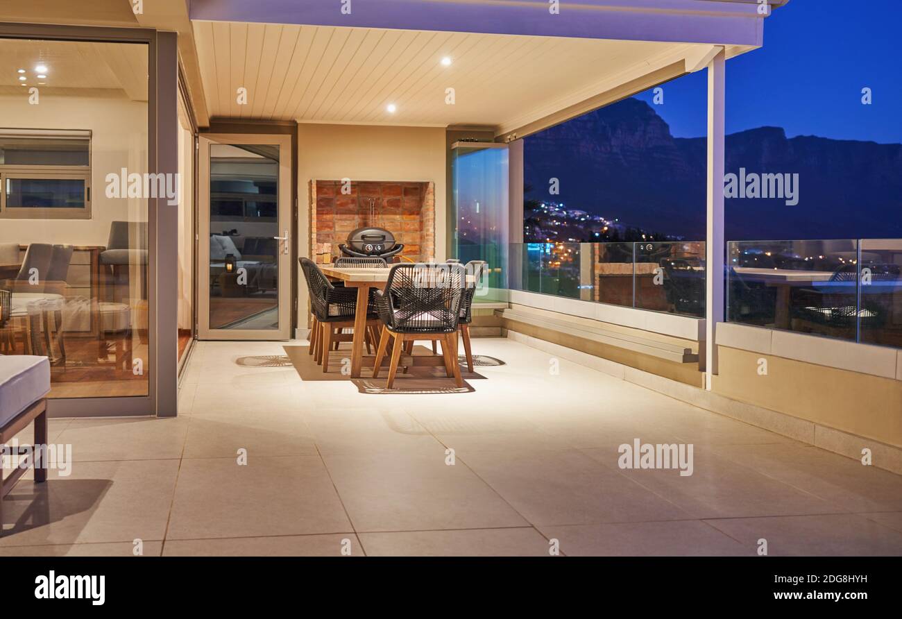 Dining table on luxury home showcase patio at night Stock Photo Alamy