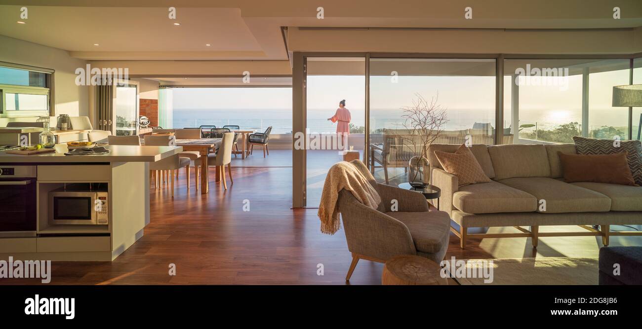 Woman enjoying scenic sunny ocean view on luxury balcony Stock Photo