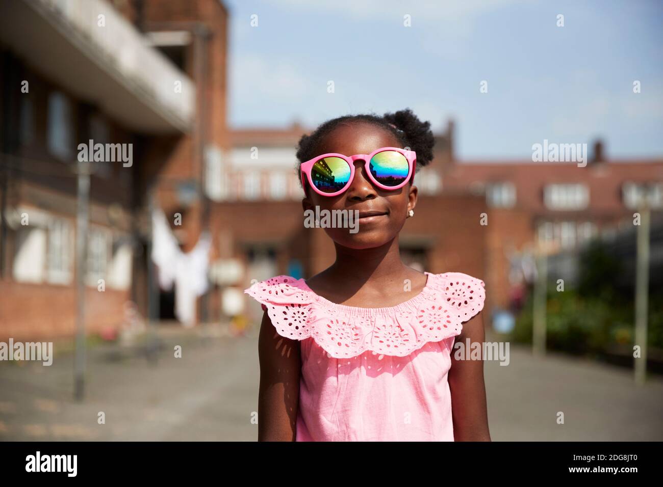 Portrait cute girl in bright pink sunglasses Stock Photo