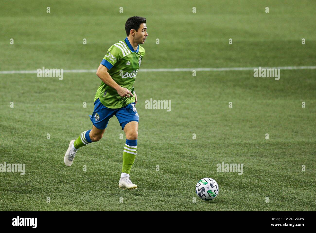Seattle Sounders midfielder Alex Roldan (16) runs with the ball during the second half of the MLS Western Conference Finals against the Minnesota Unit Stock Photo