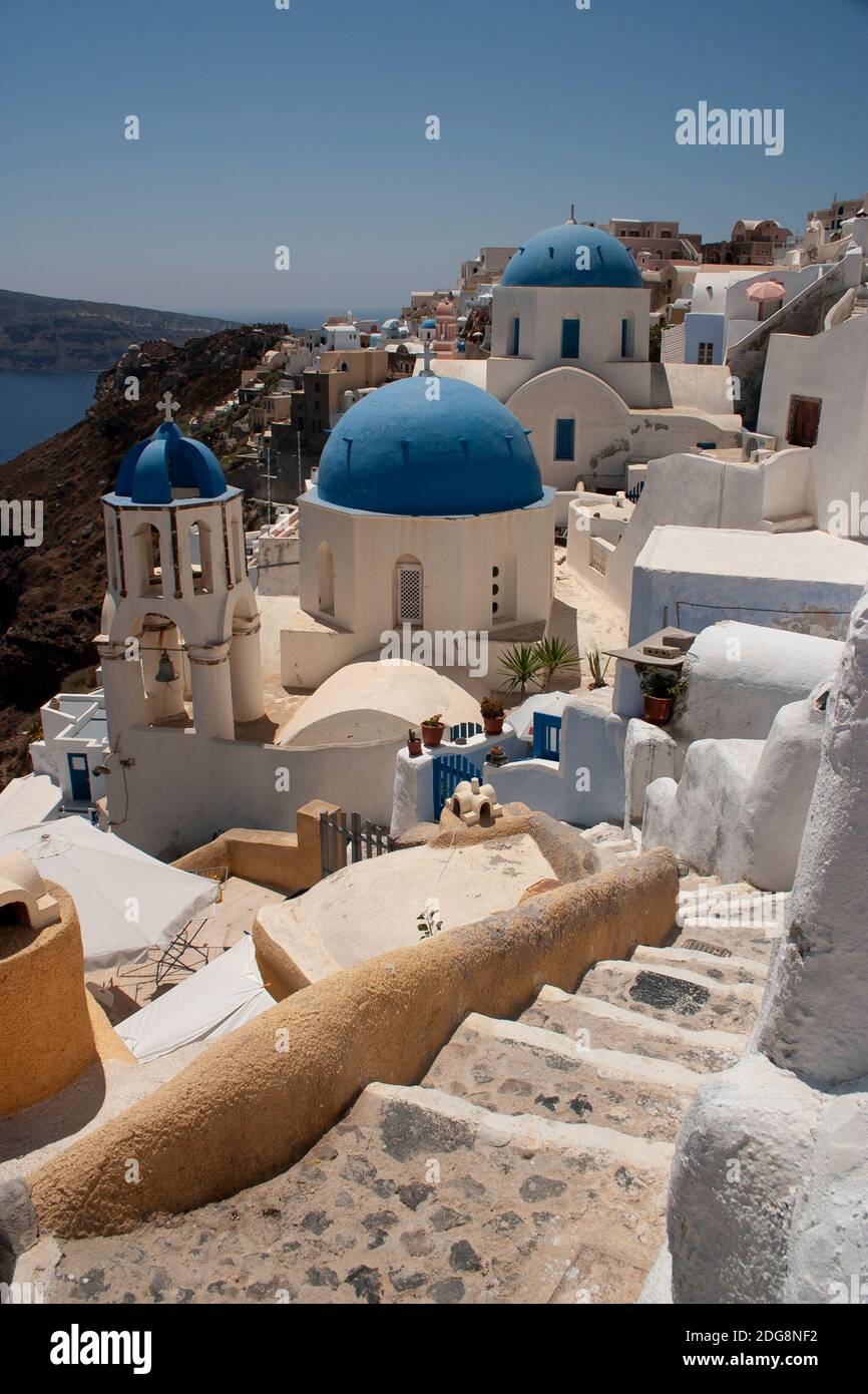 A view of the famous blue domed churches of the popular Greek island of Santorini, or Thira. Stock Photo