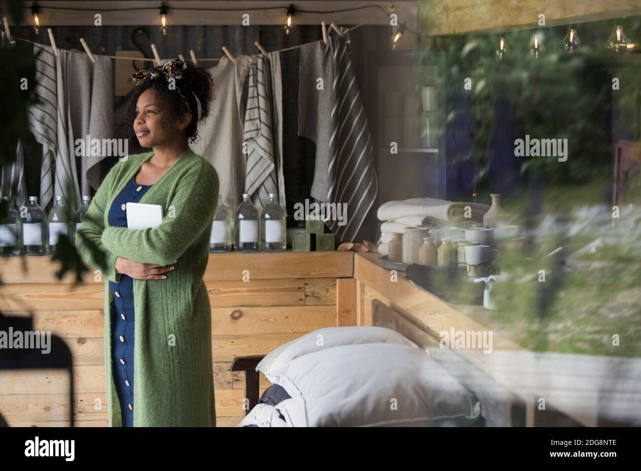 Portrait thoughtful female shop owner looking away Stock Photo