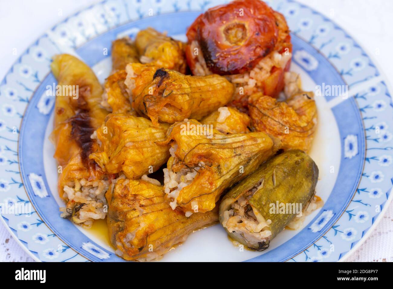 Vegetables, including courgette flowers stuffed with rice and herbs and baked  in olive oil Stock Photo