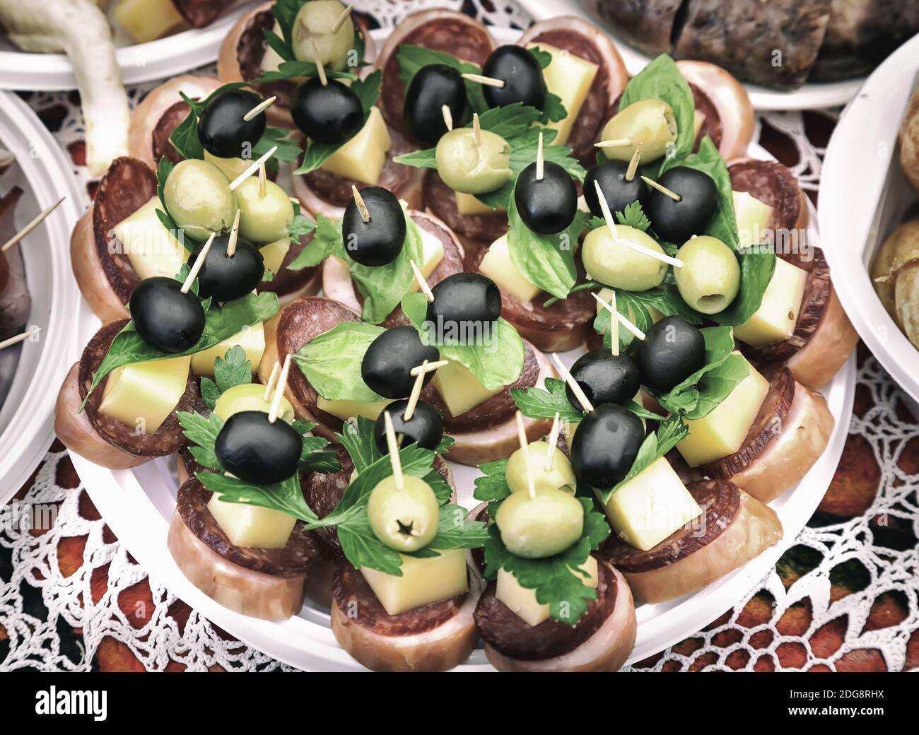 Sandwiches with cheese, sausage and olives. Stock Photo