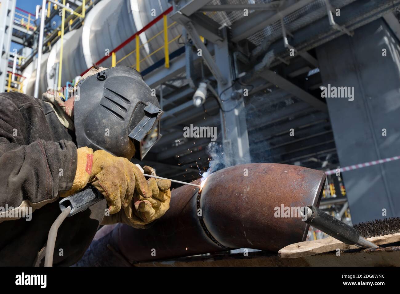 Welding works on metal  heat exchanger using manual arc welding Stock Photo