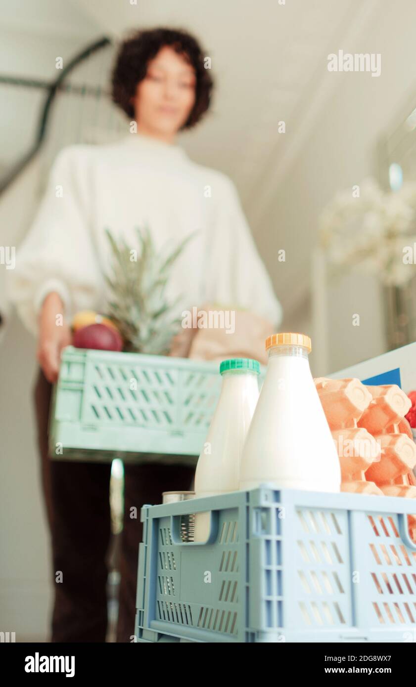 Woman receiving grocery delivery at home Stock Photo - Alamy