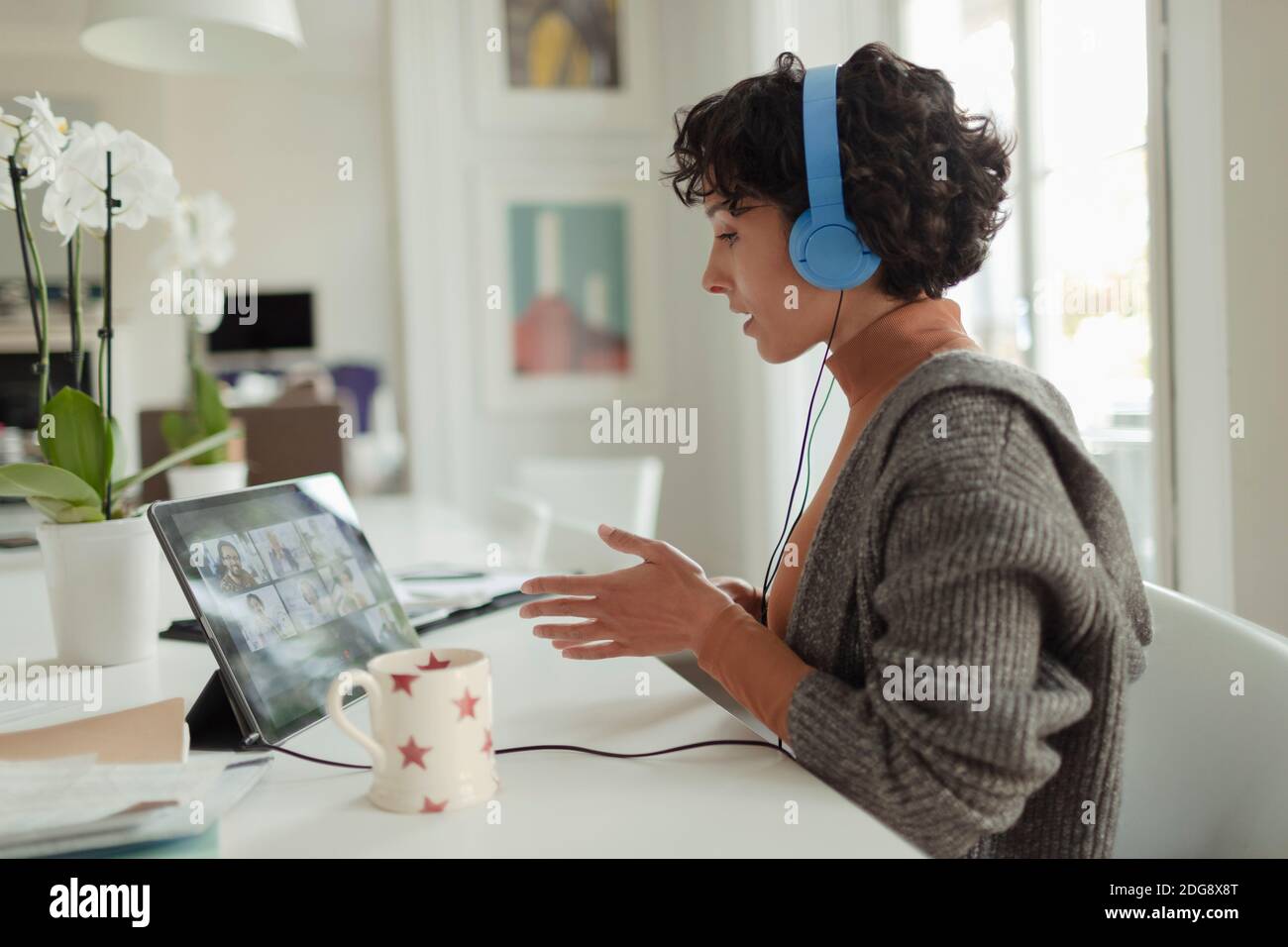 Woman working from home video conferencing at digital tablet Stock Photo