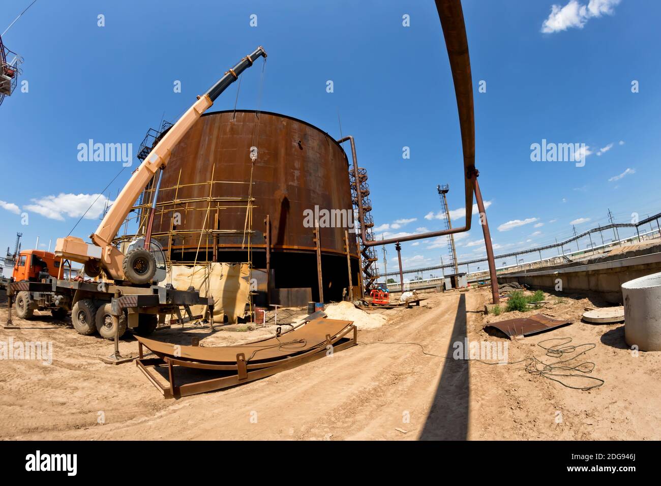 Repair work on replacement of lower belts of old rusty tank for storage of petroleum products Stock Photo