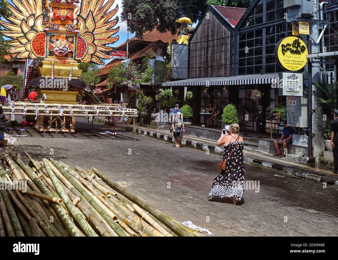 Tourists taking a photograph by the funeral pyre under construction in