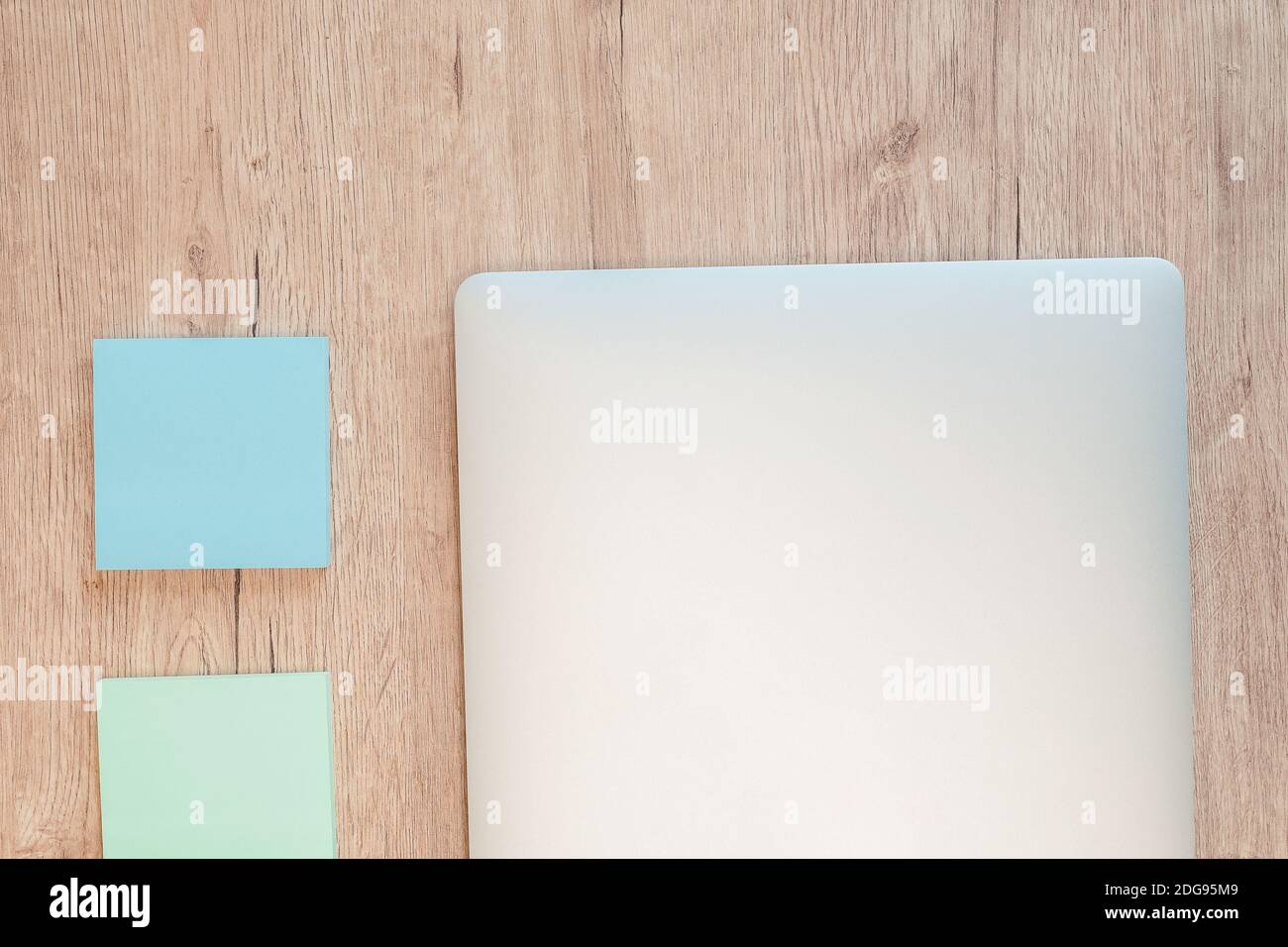 close up. sticky notes and a white laptop on the table. Stock Photo