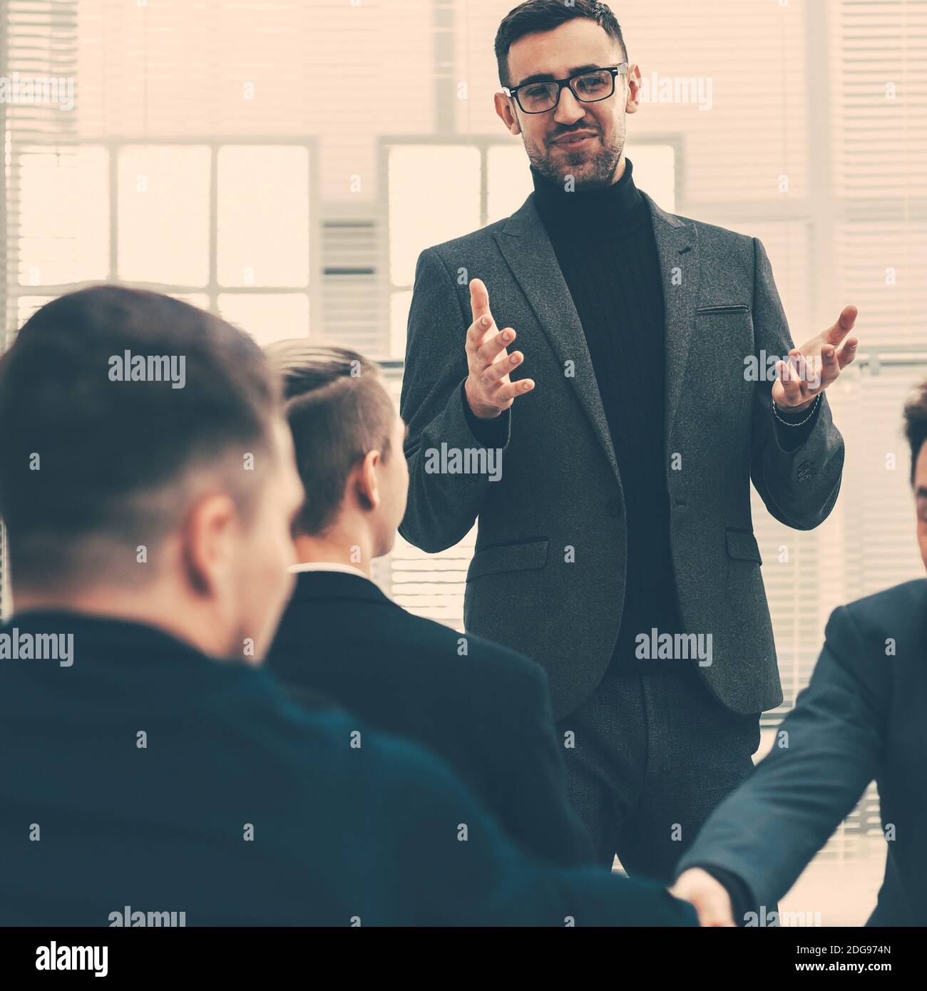 smiling employees shaking hands during a working meeting Stock Photo