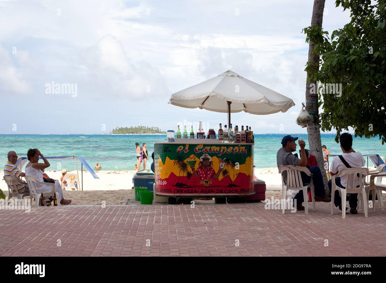 San Andres Island, Colombia, South America - People at a beach stand selling drinks in the main beach of the island. Stock Photo