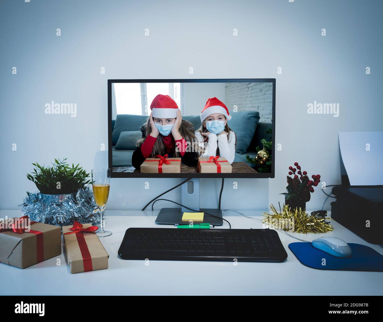 Sad children with mask in self isolation on video call with family missing celebrating christmas and new year face to face. Virtual celebrations and C Stock Photo