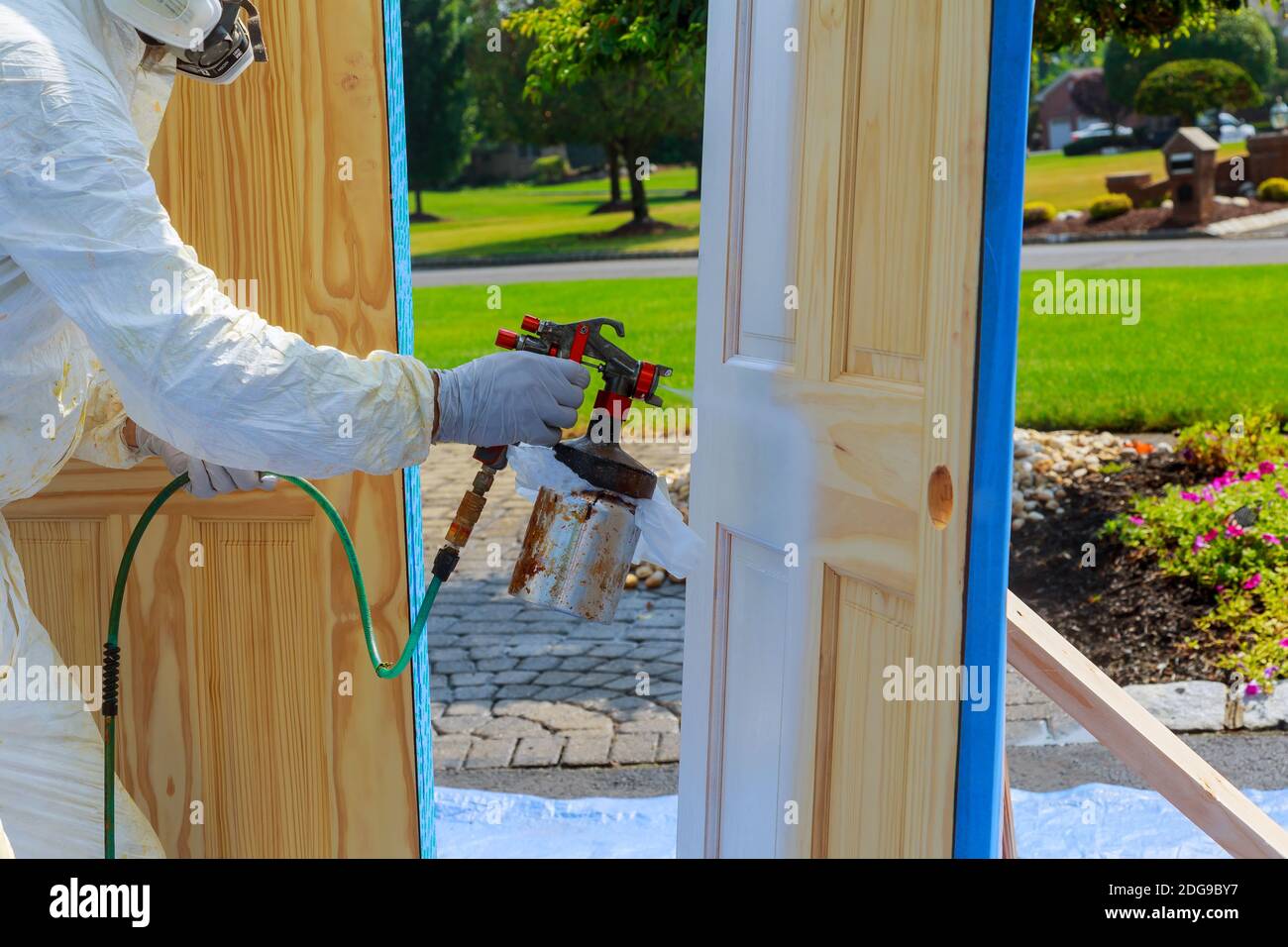 Master painting wood doors with spray gun processing painting base