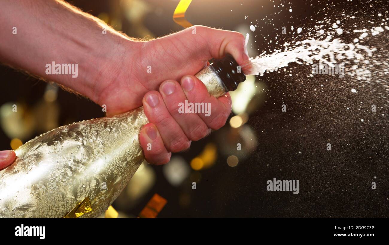Champagne popping, detail of bottle with wine explosion. Holidays and celebration theme. Stock Photo