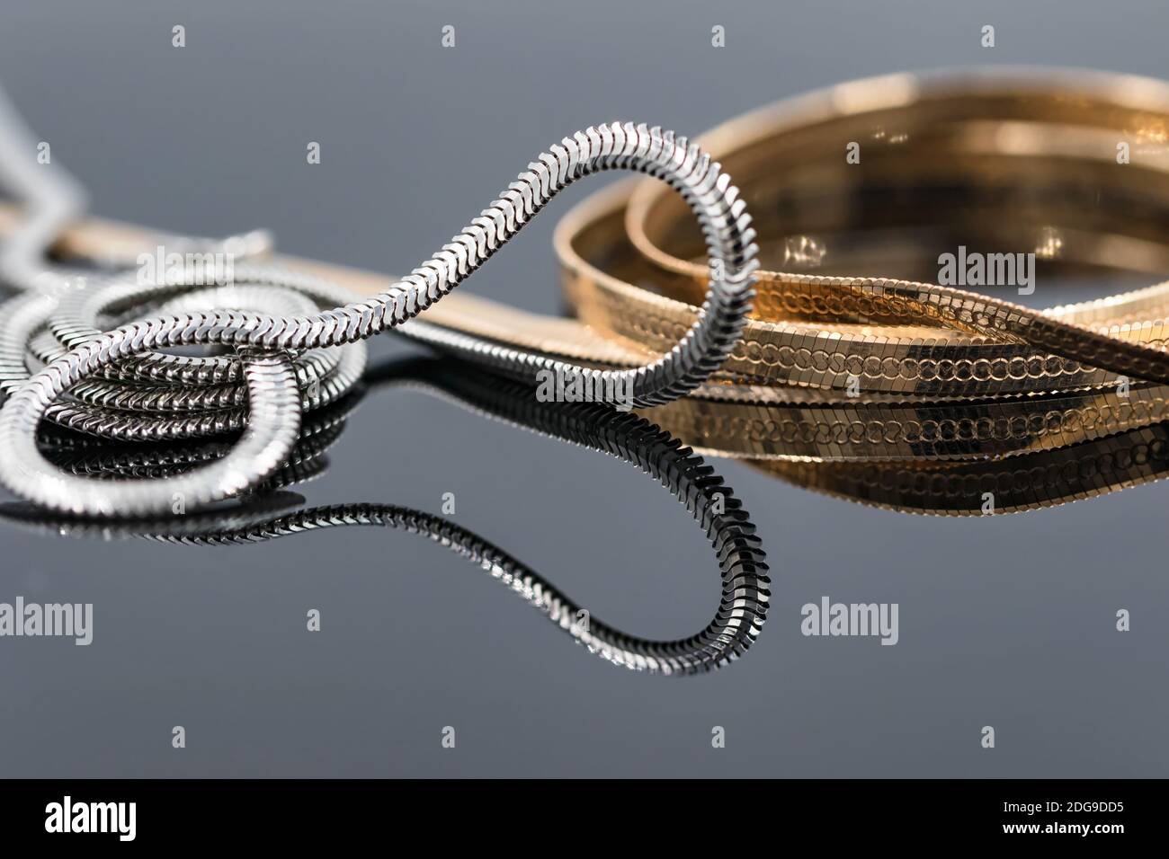 Concept choice between silver and gold chain Stock Photo Alamy