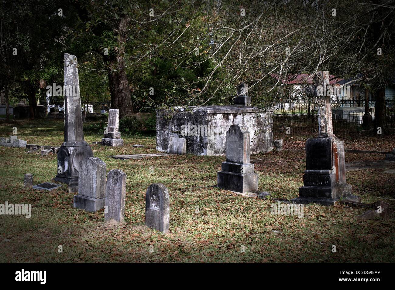 old weathered darkly stained gray tombstones in an antiquated cemetery Stock Photo