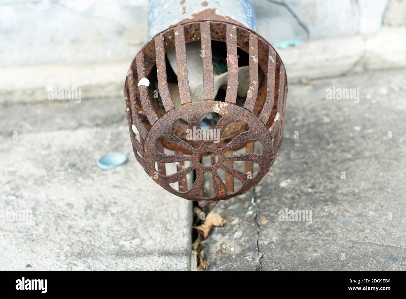 Close-UP a vintage head of a suction pump have very rust on the cement grounds. Stock Photo