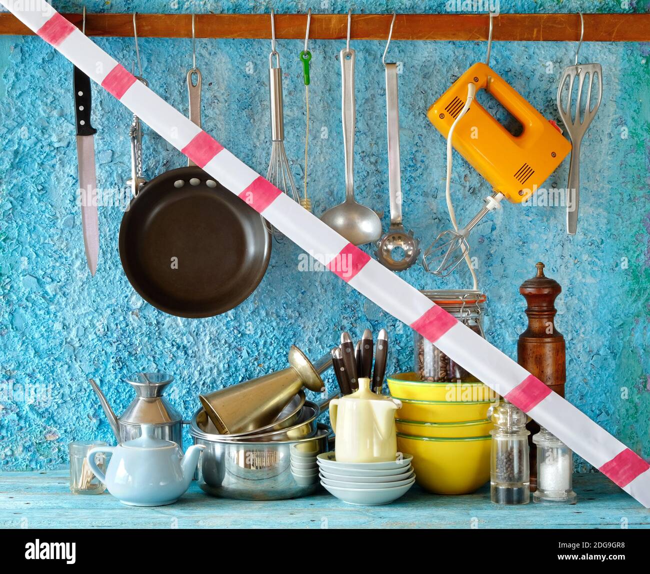 gastronomy corona lockdown, restaurant kitchen utensils with warning tape,symbolic picture Stock Photo