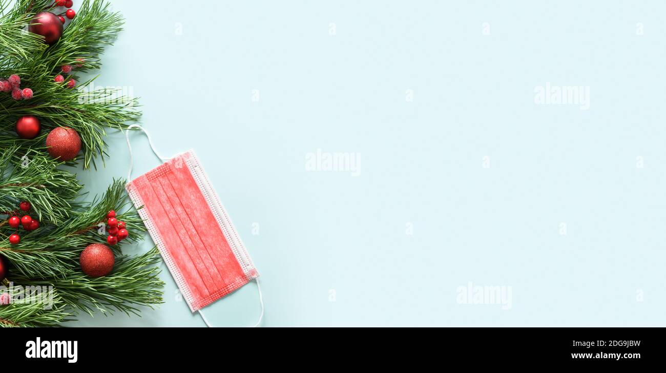 Christmas frame of red protective medical face mask and evergreen ...