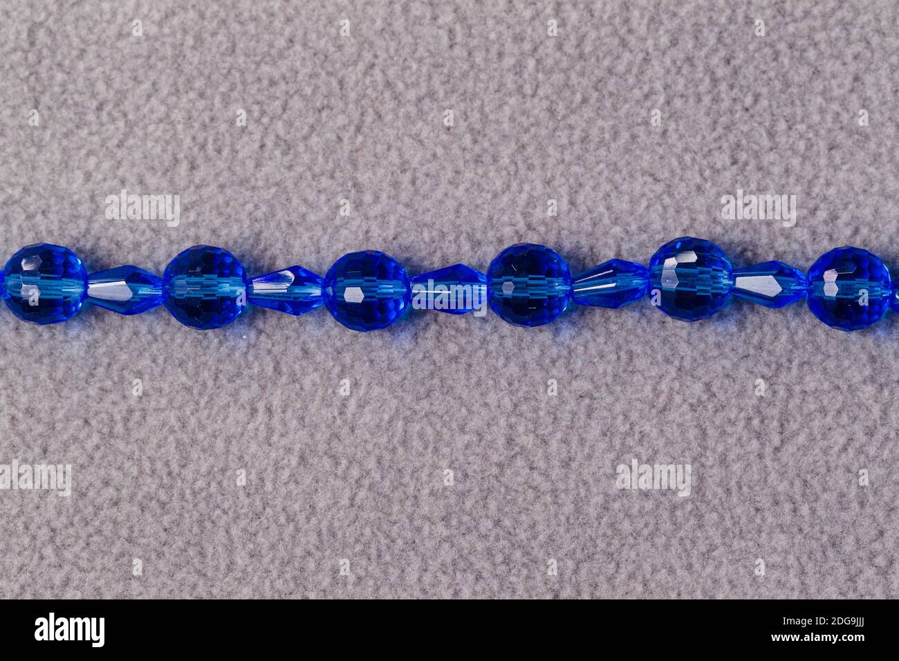stand of oval blue beads for the creation of jewelry Stock Photo