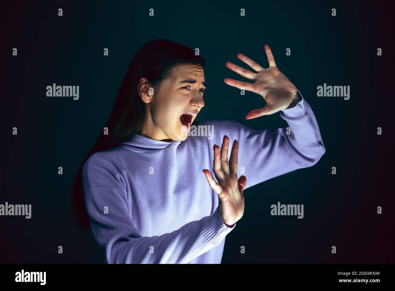 Woman Gets Scared By The Dark In Front Of Her Face Background