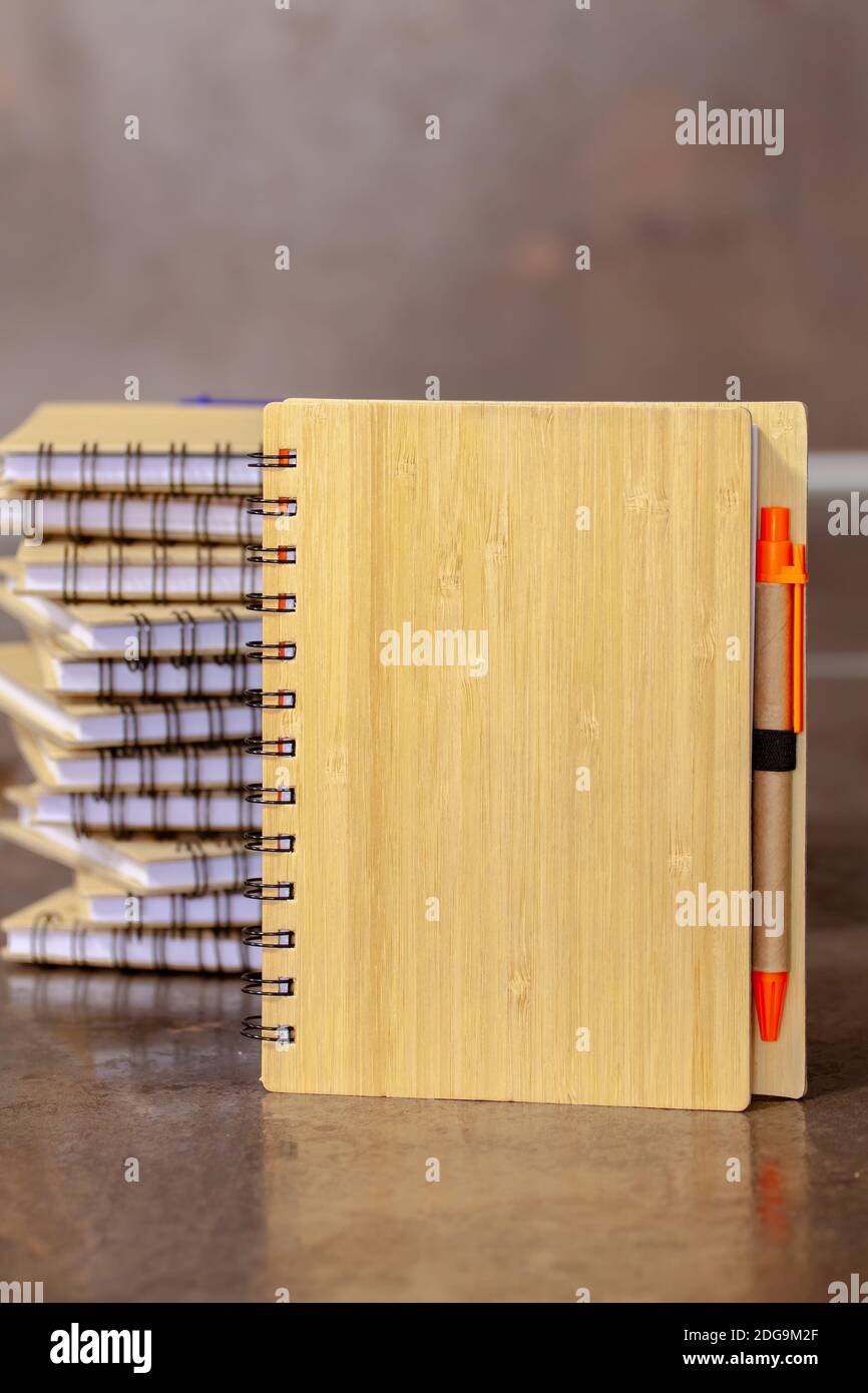 ECO notebook made of bamboo wood and recycled paper with pen. Selective focus with shallow depth of field. Stock Photo