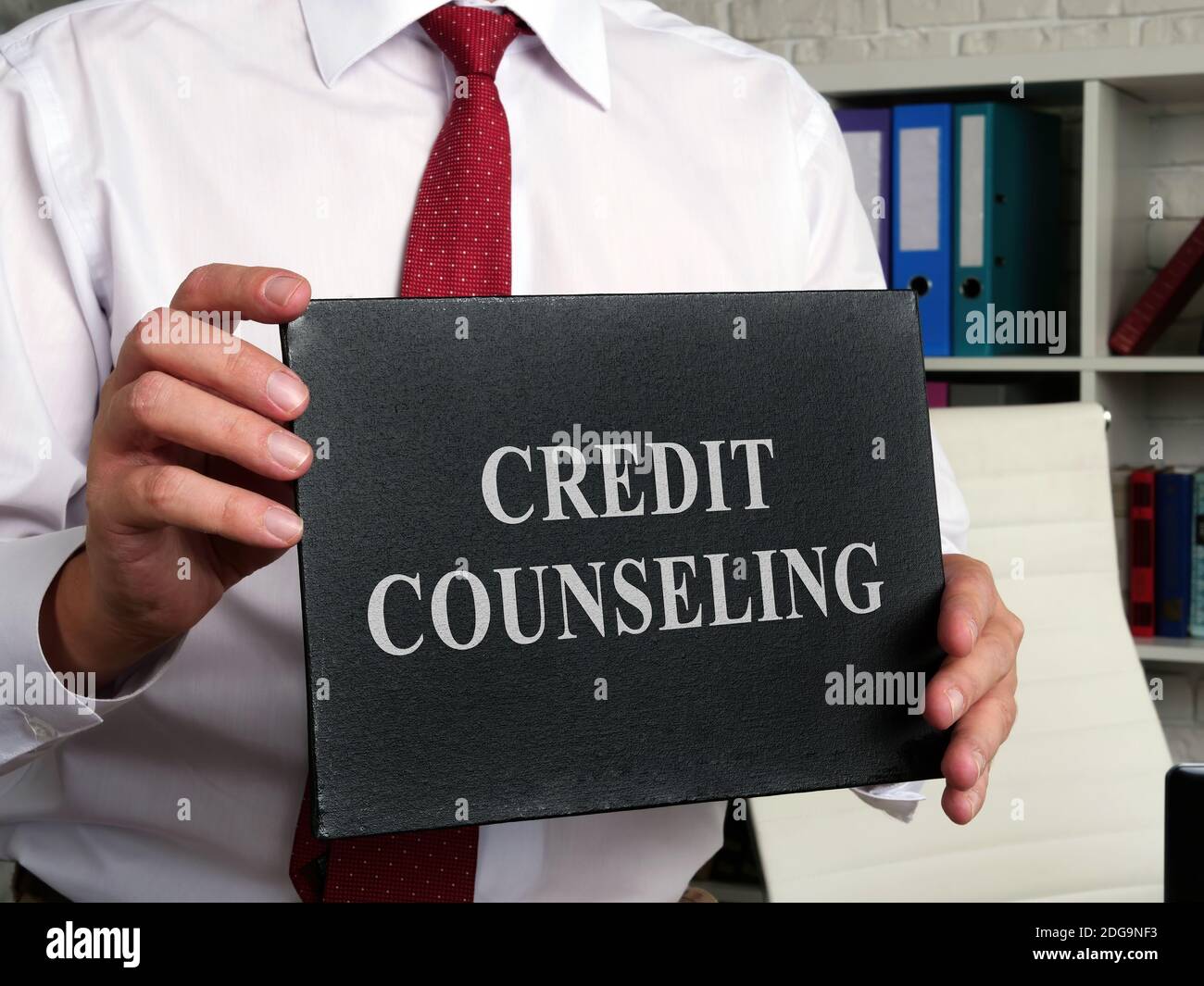 Credit counseling words on the black plate. Stock Photo