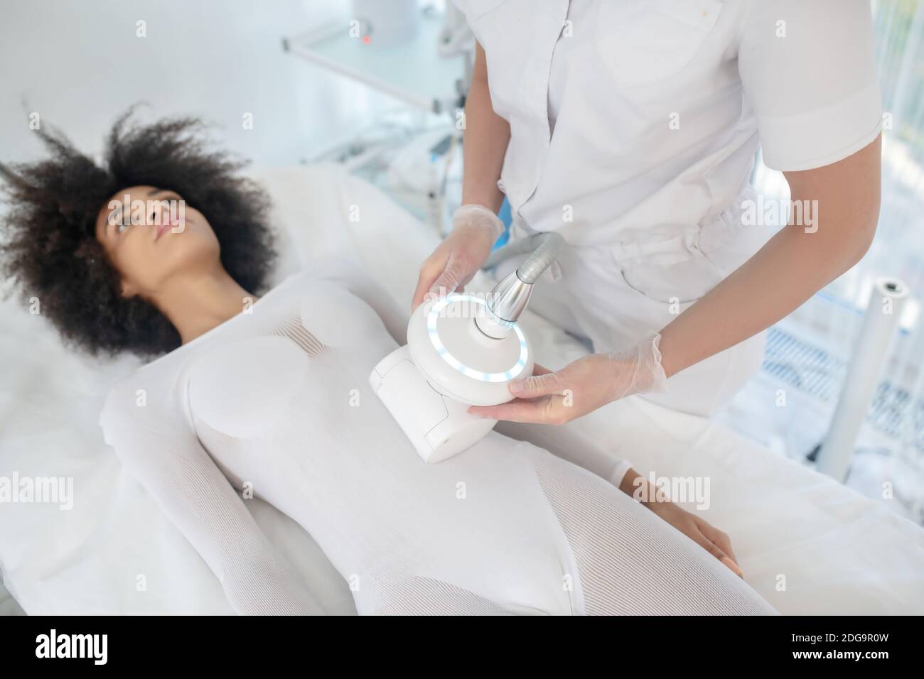 Girl lying on daybed during cosmetic procedure Stock Photo