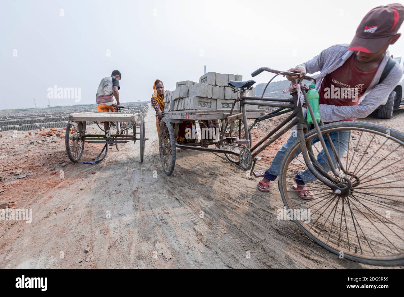 After the raw clay bricks are dried, they are stacked up inside a fixed