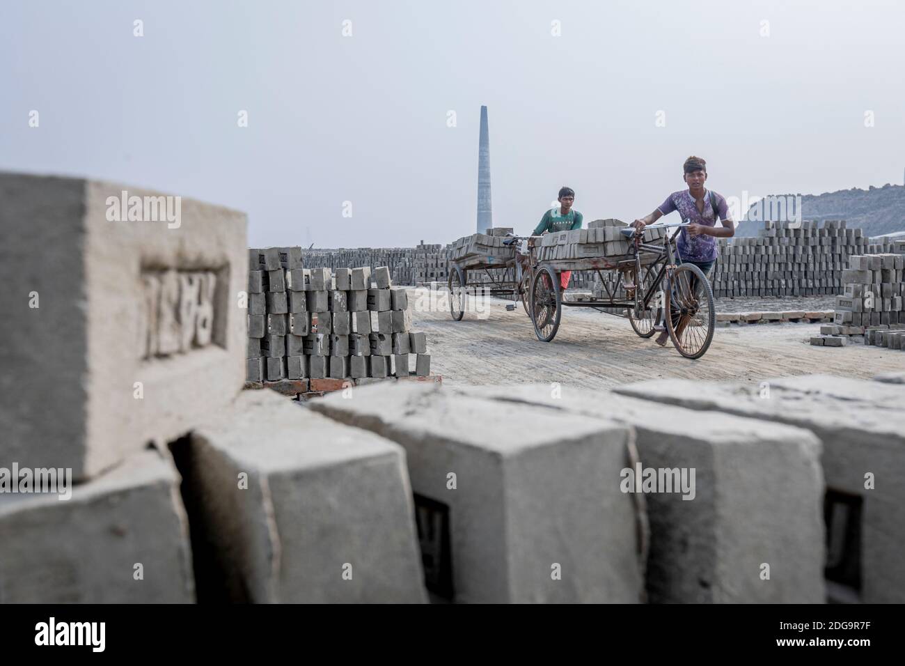 After the raw clay bricks are dried, they are stacked up inside a fixed
